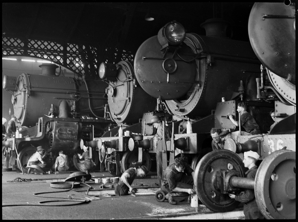 Men working on  locomotives in railway workshops, November 1941