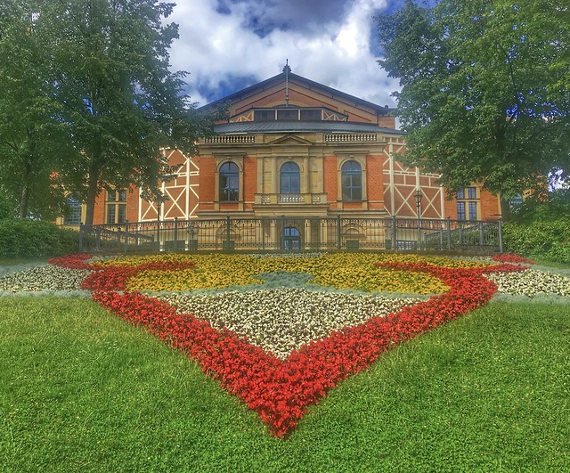 Bayreuther Festspielhaus with flowerbed on a sunny day in Wagner city Bayreuth
