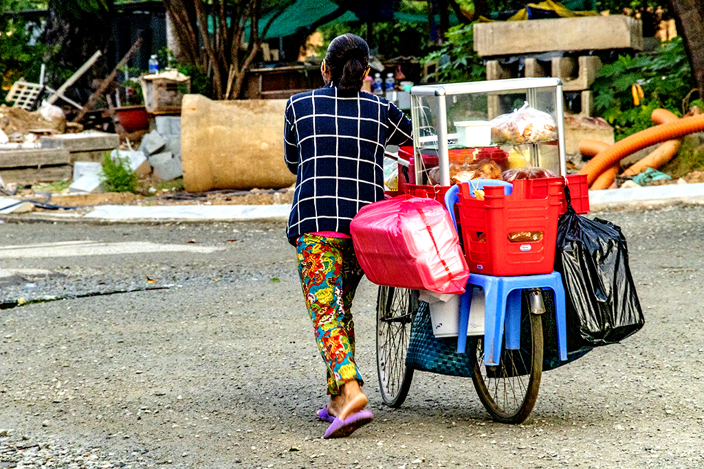 Woman pushing her food setup on a bicycle at 5 45AM on 7-19-22--Vung Tau copy