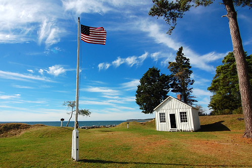 Small building with an American Flag on a pole