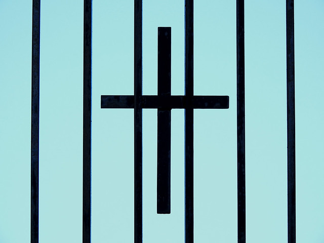A cross behind bars...
