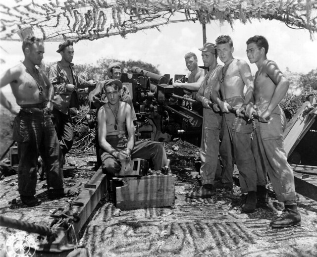 SC 335368 - Gun crew of 105mm howitzer cleaning up.