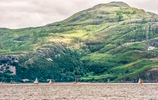 Yachts sailing on Loch Sunart below Ben Hiant, part of a an extinct volcano, Ardnamurchan, Scotland.