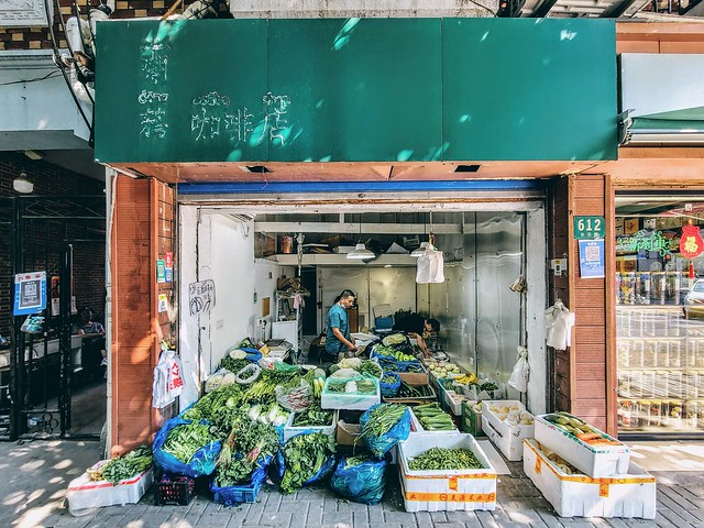 This vegetable shop was a café only half a month ago. It is not clear when the café was transformed into its present state, only traces of the café's signage characters remain upon the shop's lintel.