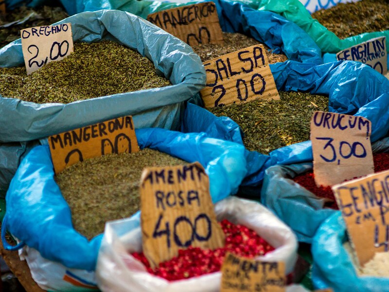 A few blue bags with different spices and herbs in the market