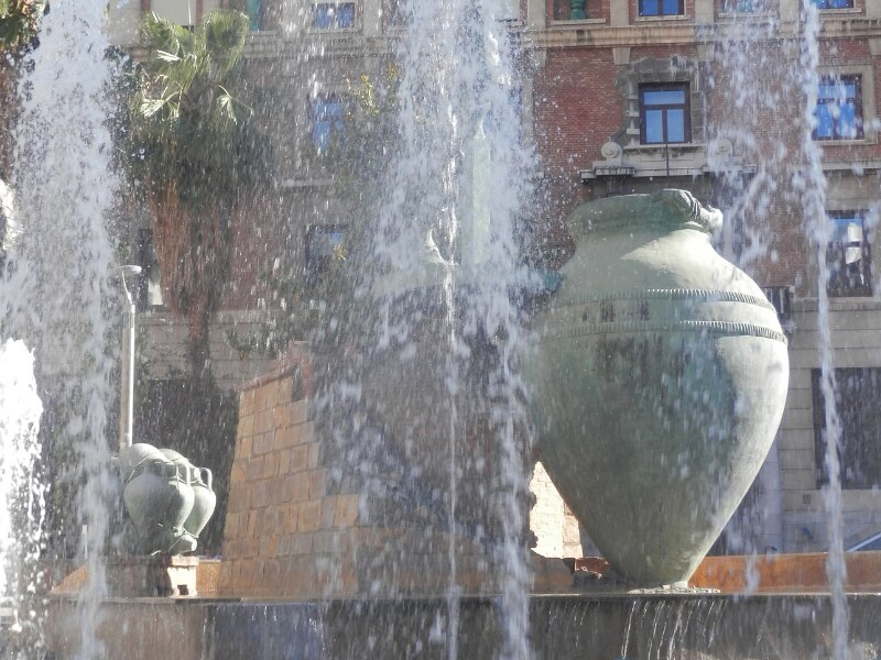 The Roman amphoras seen through the water of a fountain
