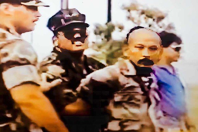 Fanohge CHamoru Exhibition Section 5: Oral Histories. Video still of the arrest of CHamoru rights activist Angel Santos for trespassing on federal property in 1993. Guam Museum collection