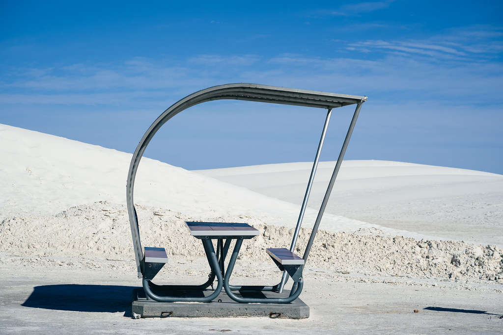 Retro style picnic rest area tables and structures inside of White Sands National Park in New Mexico