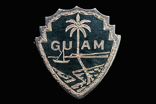 Fanohge CHamoru Exhibition Section 5: Oral Histories. Guam Seal Pin. Peter Diaz collection