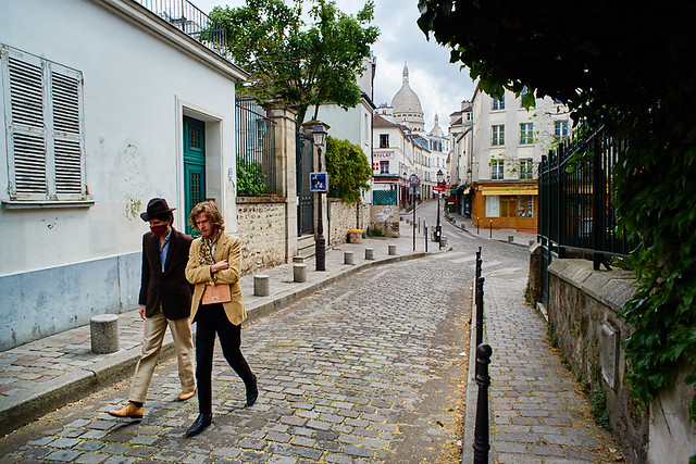 Paris, France - April 2020: during the COVID-19 lockdown, on the exit allowance time, two men dressed in Boheme fashion style are walking around Montmartre, rue Caulaincourt.