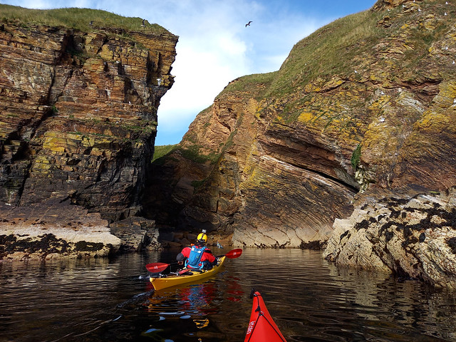 Dunbeath, Traigh Sgreadain, cliff collapse. Brian Arrowsmith in his Capella sea kayak.