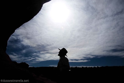Silhouette of another group member under Covert Arch near Lost Spring Canyon, Arches National Park, Utah