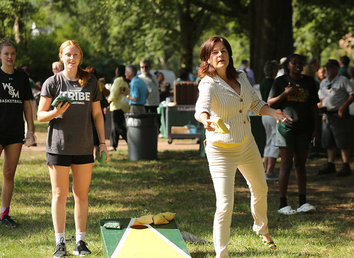 W&M President Katherine A. Rowe shows her competitive side during Employee Convocation playing a game of cornhole with a member of the women’s basketball team.