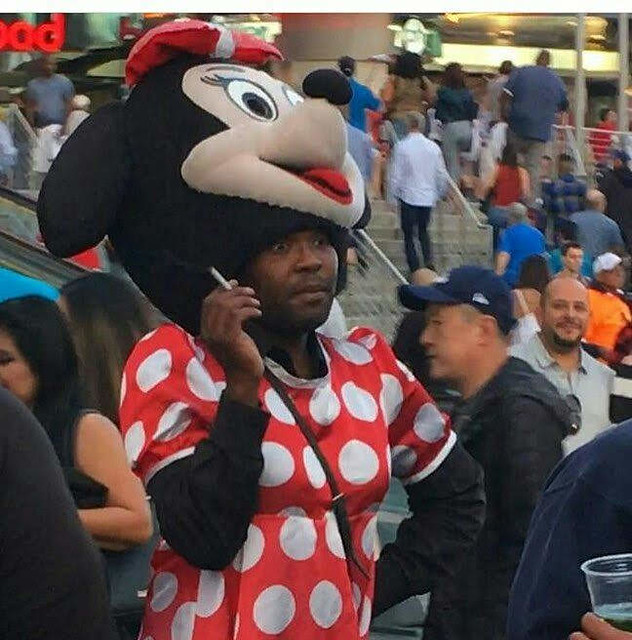 Man unmasked Minnie Mouse mascot costume