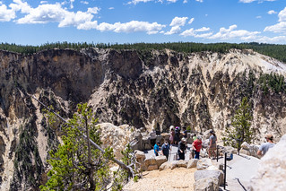Wyoming, USA - June 29, 2021: Tourists enjoy the view from Inspiration Point in Yellowstone National Park, in the canyon area, looking down at the river