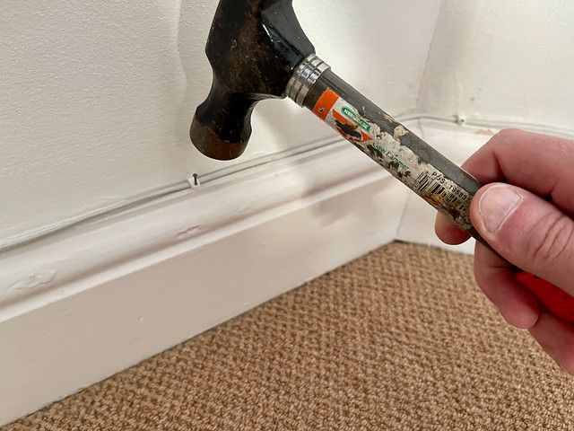 Clipping cable to skirting board