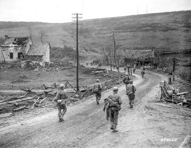 SC 270665 - Infantrymen of the 12th Infantry Regiment, 4th Division, U.S. Third Army, near Prum, Germany, move up to attack the town. 28 February, 1945.
