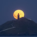 The moon rising behind Ballycotton Lighthouse, East Cork