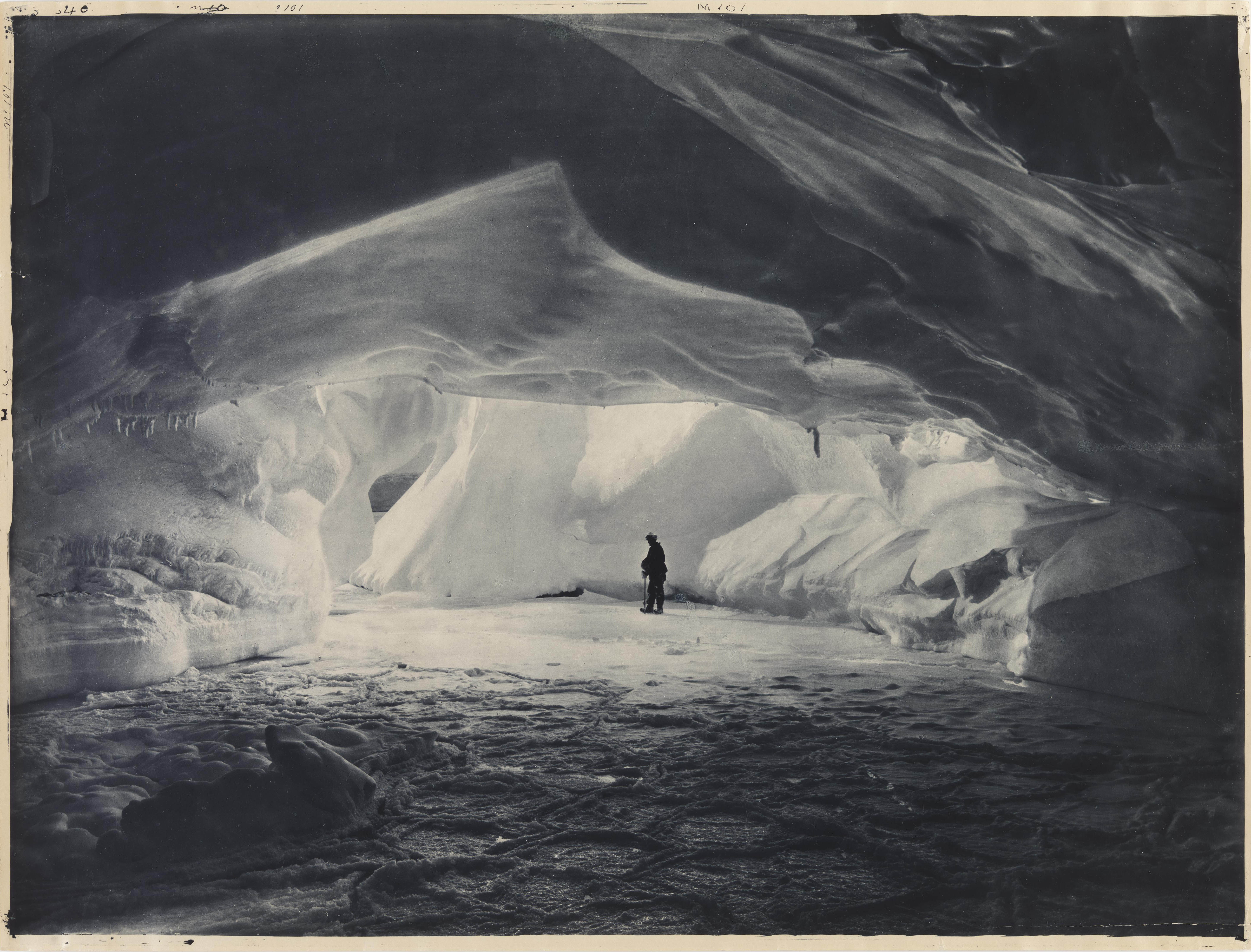 Frank Hurley :: A man (Leslie H. Whetter?) stands in a cavern carved by the sea in an ice wall near Commonwealth Bay, 1911-1914. Silver gelatin photoprint. From: Australasian Antarctic Expedition, 1911-1914 : original pictorial material reproduced in the `Scientific reports'. | src State Library of New South Wales website & its Flickr account