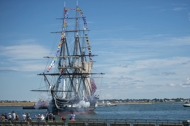 USS Constitution fires a 21-gun salute from its saluting batteries off the coast of Castle Island, Mass.