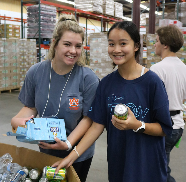 Two students work at the food bank.