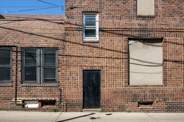 A good grid of square bricks from 1916 surrounds an emergency exit door.