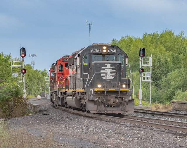 Led by ex-Illinois Central SD40-2 6260, a Canadian National train of ore cars loaded with ballast rock reaches the summit of Minnesota’s Proctor Hill after a steep climb from Duluth Harbor on the former Duluth Missabe and Iron Range Railway. 08/18/2022.
