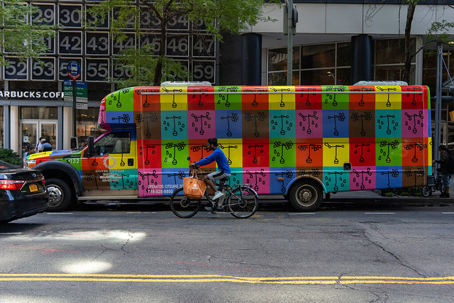Silver Towers Rainbow Bus with Cyclist