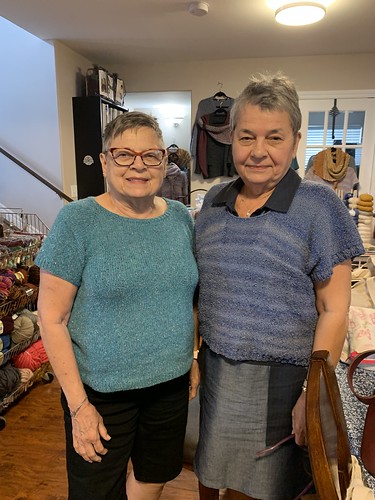 Sisters, Bev (on the left) in her Top Down Swing Pullover by Diane Soucy knit with Berroco Remix Light and Connie (on the right) in her Over the Top Tee by Heidi Kirrmaier knit with yarn she bought at her Florida LYS.