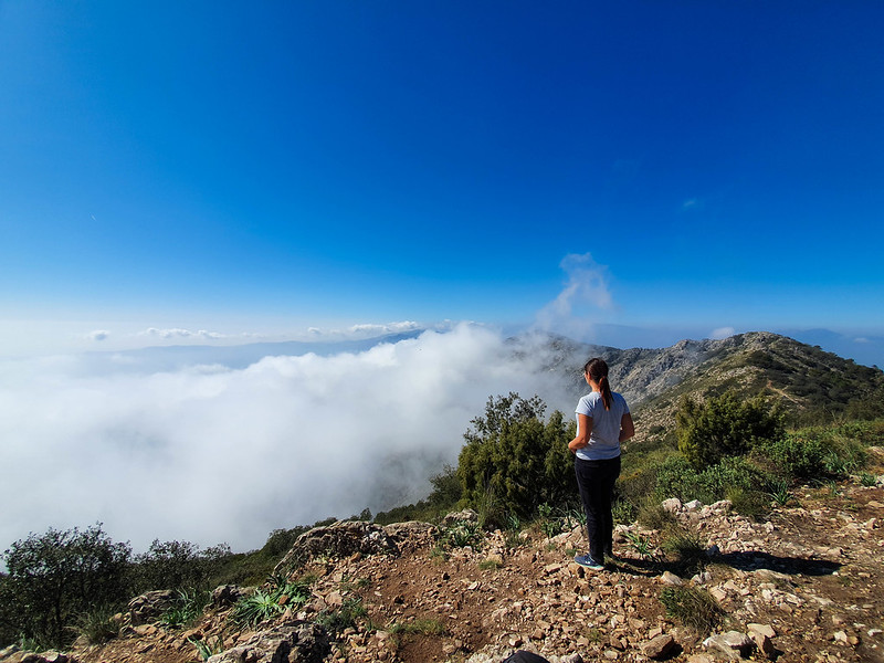 I am standing on the peak of Mijas, looking at the white clouds raising from underneath.