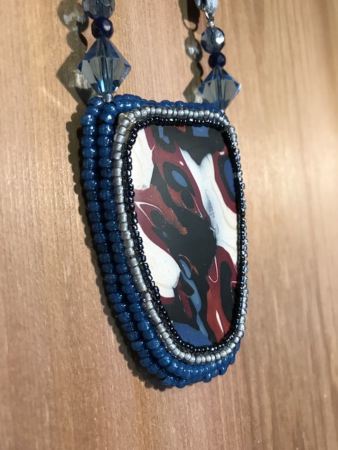 Sarah Harriz polymer clay necklace with hand-beaded bezel and sari silk cord.