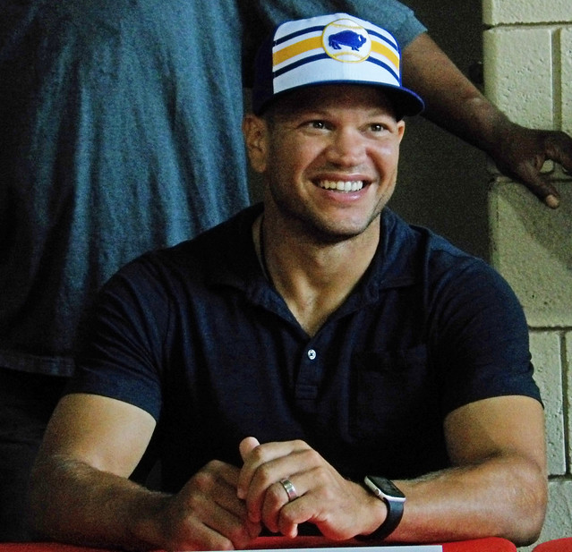 E615 Kyle Okposo of the Buffalo Sabres signing autographs before the game.