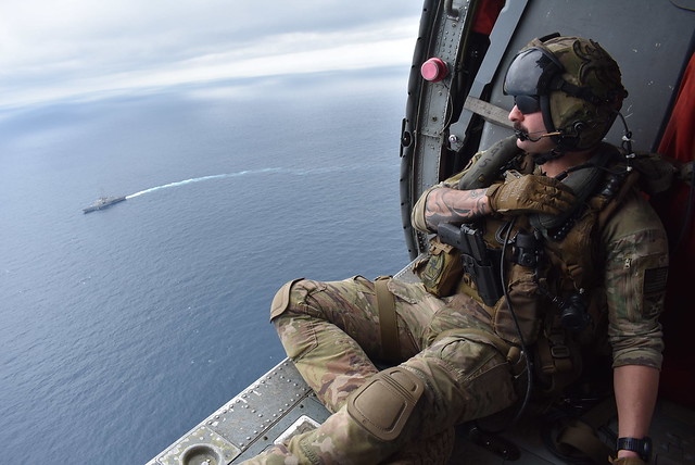 Naval Aircrewman Helicopter 1st Class Benjamin Cellew overlooks USS Billings (LCS 15) during flight operations in the Pacific Ocean.