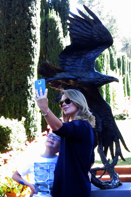 Woman taking selfie of her and her son with sculpture of eagle in background at Filoli Estates 20170923-131106