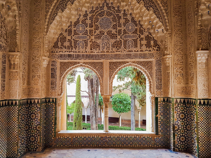 A window inside the Alhambra. The frame is decorated with intricate small sculptures and details representing Arabic motifs