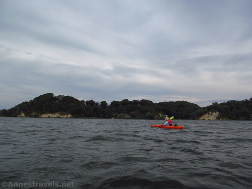 Kayaking through the choppy water of Irondequoit Bay below the cliff of Abraham Lincoln Park, Webster, New York