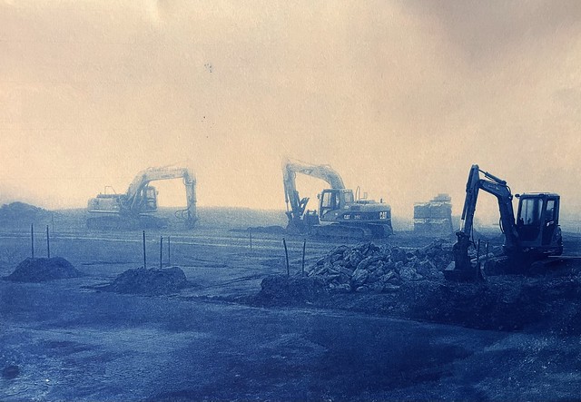 Hydraulic Shovels in the Mist: an earthy, yet moving, photograph