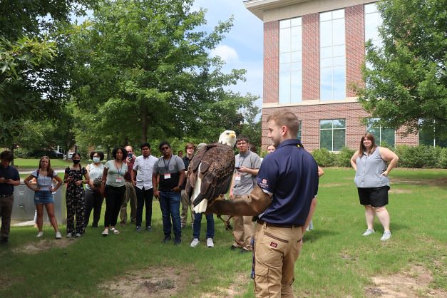 A Southeastern Raptor Center representative talks to students about raptors' brain functions.