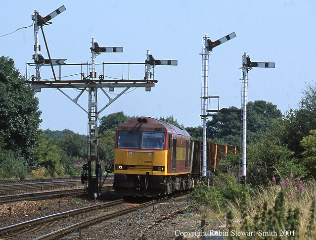 EWS Class 60 No 60049 heads an Immingham to Santon loaded iron ore hoppers working approaching Barnetby East Signal Box on 26th July 2001 (Copyright Robin Stewart-Smith - All Rights Reserved)