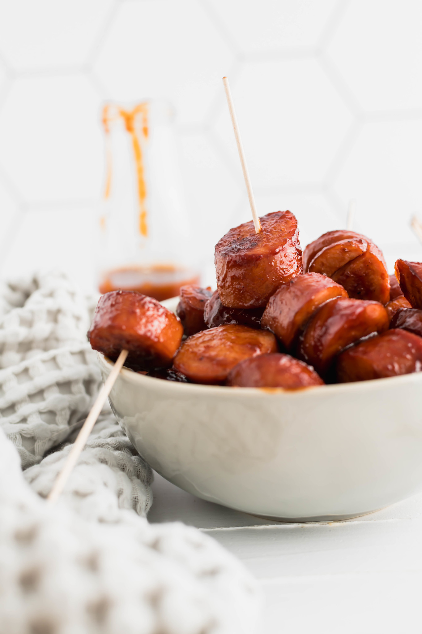 BBQ Kielbasa Bites in a gray bowl, a few with toothpicks in them.