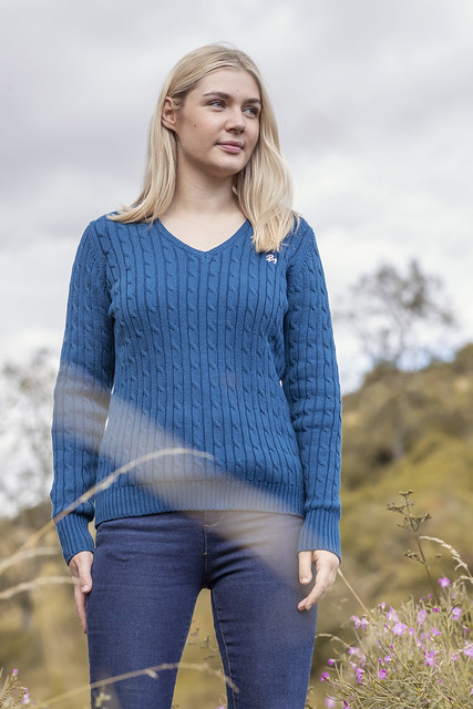 Women stood in the woods wearing a cable knitted jumper