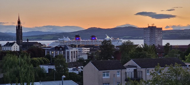 The sunrise catches The Disney Magic  in Greenock on the river Clyde