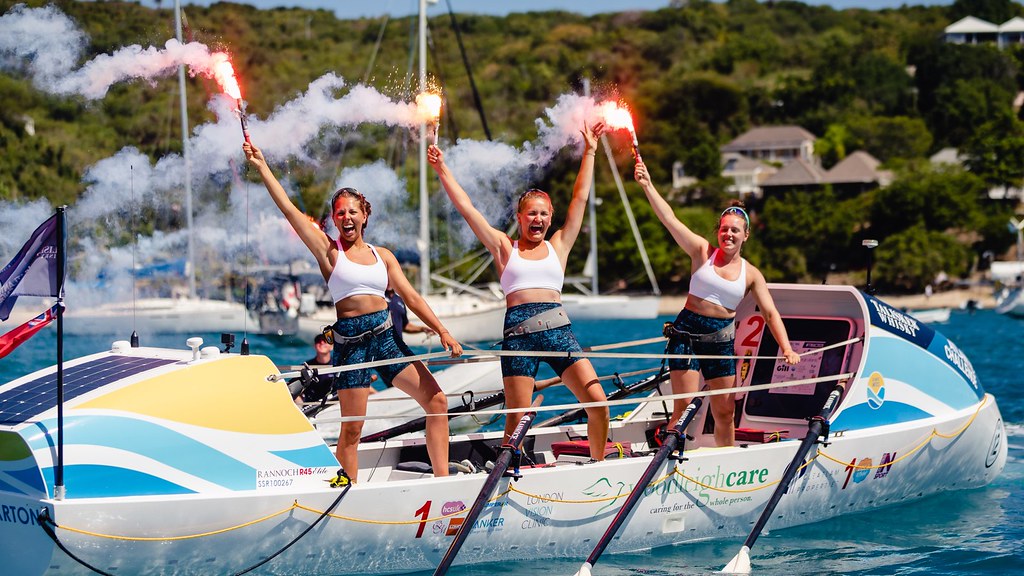 Flo and her fellow rowers on their boat at the finish line in Antigua