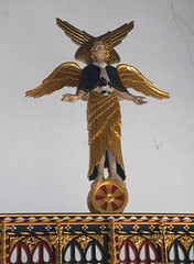 six-winged seraph standing on a wheel (Ninian Comper, 1913)