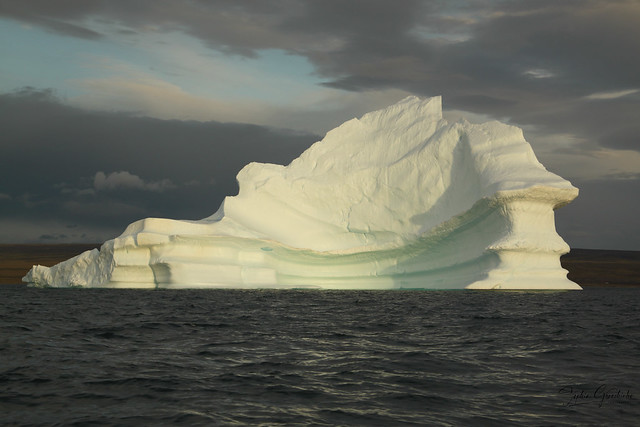 Stranded tabular iceberg and ice near evening in arctic landscape, near Pond Inlet, Nunavut