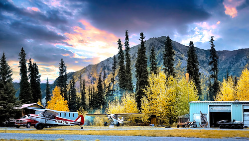 Moose Hunters Camp - Alaska by JLS Photography - Alaska, I caught this bush plane just after it dropped off a successful hunter. 

On the ground from right t