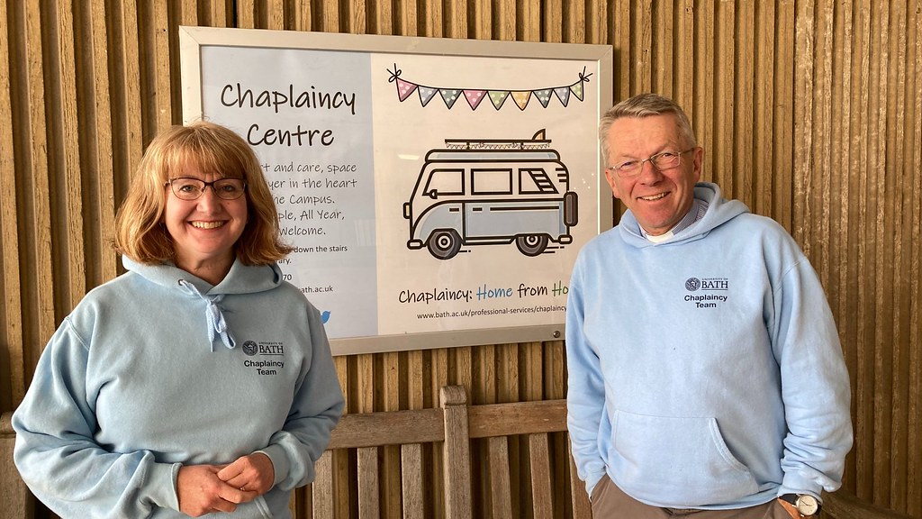 Chaplains Karen and Nigel stand in front of the Chaplaincy Welcome Week sign