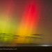 Green and Red Auroral Curtains Mixing