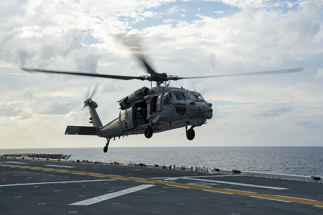 A MH-60S Sea Hawk lands on USS America in the Pacific