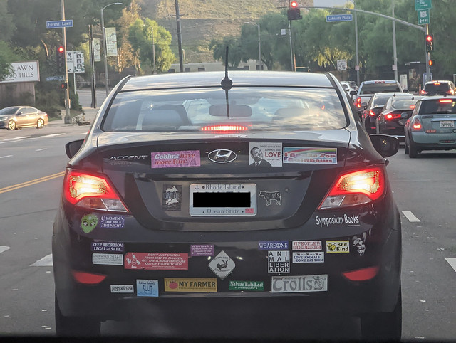 Car with Rhode island plates and many bumper stickers, Burbank, California, USA